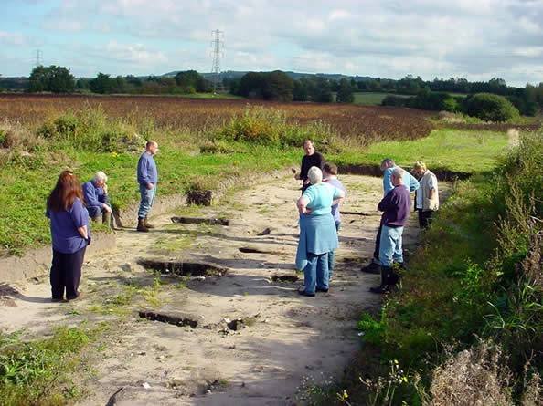 Members viewing the Roman-period road surface at Lathom