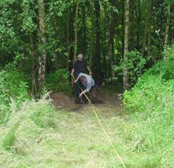 Opening a test pit among the trees