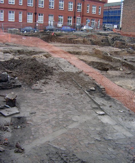 A stone-flagged floor emerging from the demolition rubble at Millgate