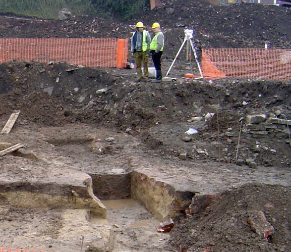 Surveying the hypocaust building from the spoil heap