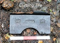 A cast iron kerbing tile from the path