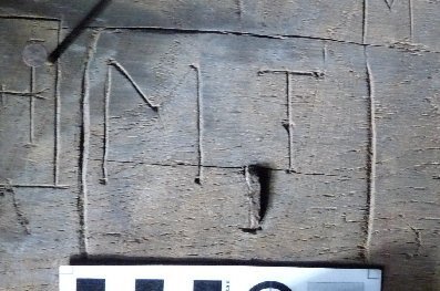 Engraved letters ‘M T’ – with serifs