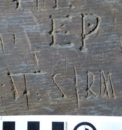 Array of faintly scratched marks including an inverted V and 3 Double-V shapes