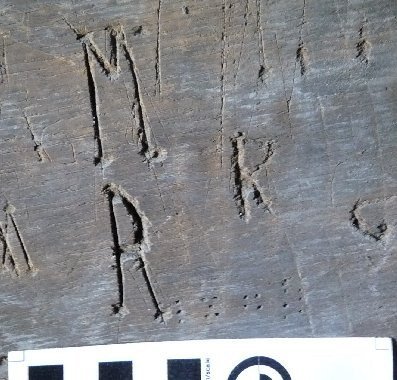 Engraved letters ‘M R’ arranged vertically