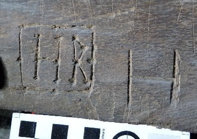Engraved letters ‘M R’ arranged vertically